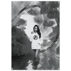 A black and white poster print featuring a woman in a white sweatshirt with a circular logo, standing in reflective water against a surreal, swirling abstract background.