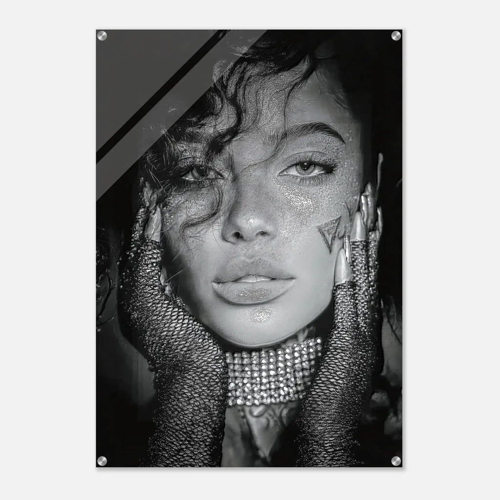 A black and white fashion portrait print of a woman with glitter, rhinestone gloves, and dramatic hair, shown as a poster or wall art with visible mounting holes.