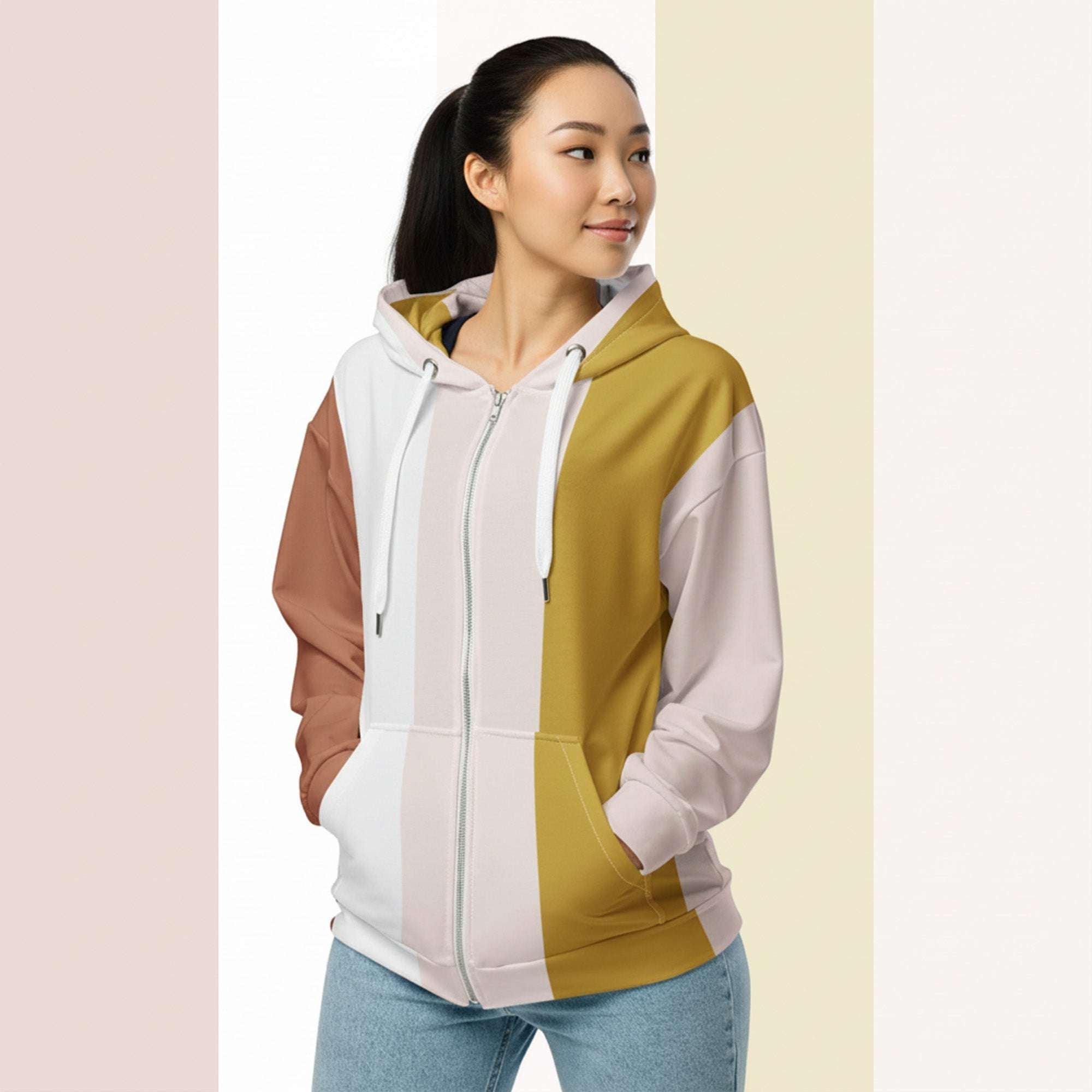 Three‑quarter side view of the second woman wearing the Her Palette Strip Hoodie No. 04; pastel vertical stripes accent the body and sleeves, lavender hood and white drawstrings, pastel striped backdrop, pocket detail visible from Form Finding Design.