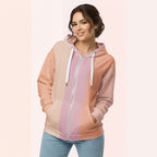 Front view of another woman wearing the Her Palette Strip Hoodie No. 05; pastel stripes cover the torso and sleeves, lavender hood lining and white zip, hands resting in the kangaroo pocket, pastel striped background from Form Finding Design.