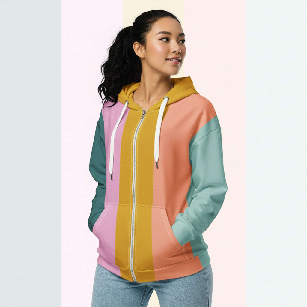 Three‑quarter side view of the second woman wearing the Her Palette Strip Hoodie No. 12; pastel vertical stripes accent the body and sleeves, lavender hood and white drawstrings, pastel striped backdrop, pocket detail visible from Form Finding Design.
