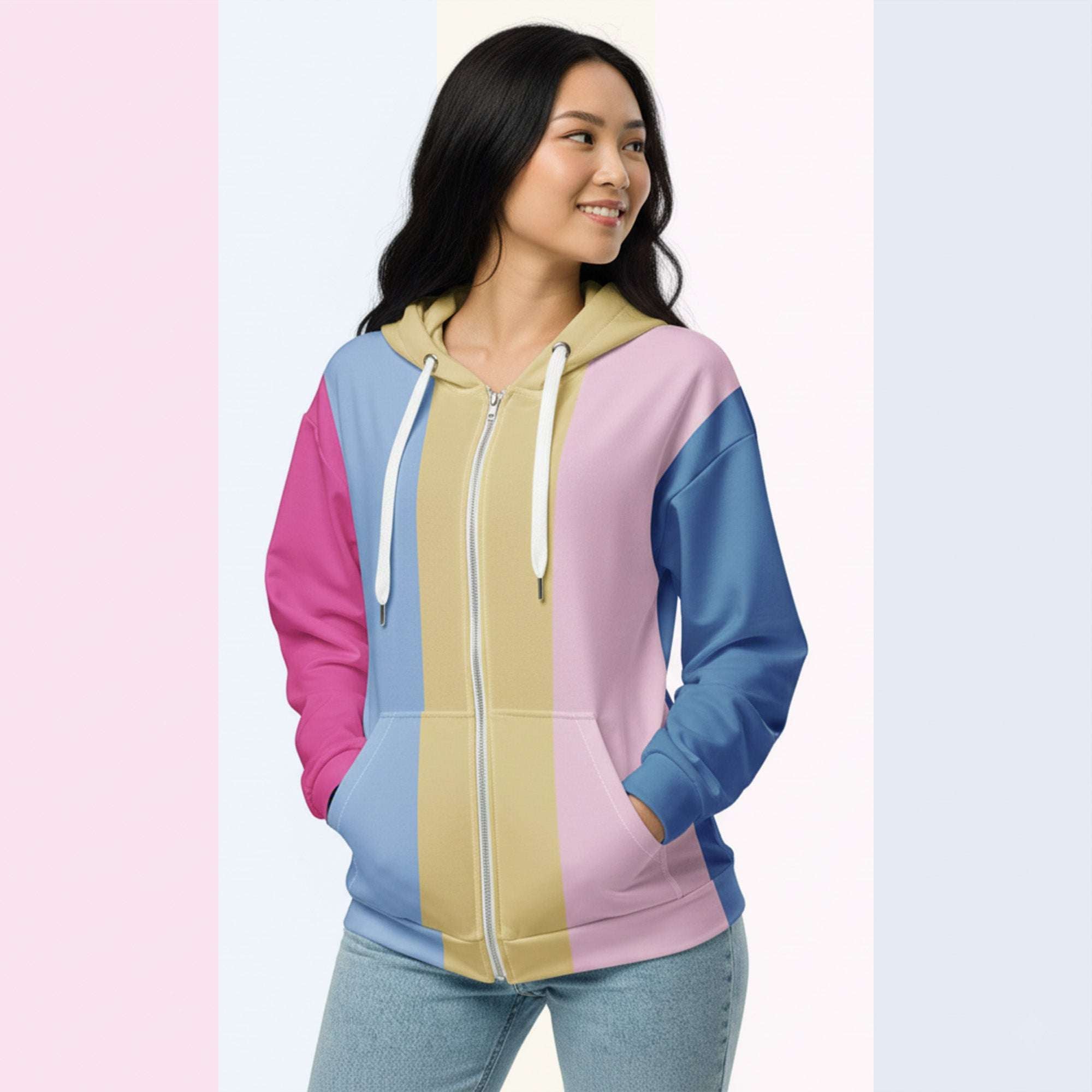 Three‑quarter side view of the second woman wearing the Her Palette Strip Hoodie No. 16; pastel vertical stripes accent the body and sleeves, lavender hood and white drawstrings, pastel striped backdrop, pocket detail visible from Form Finding Design.