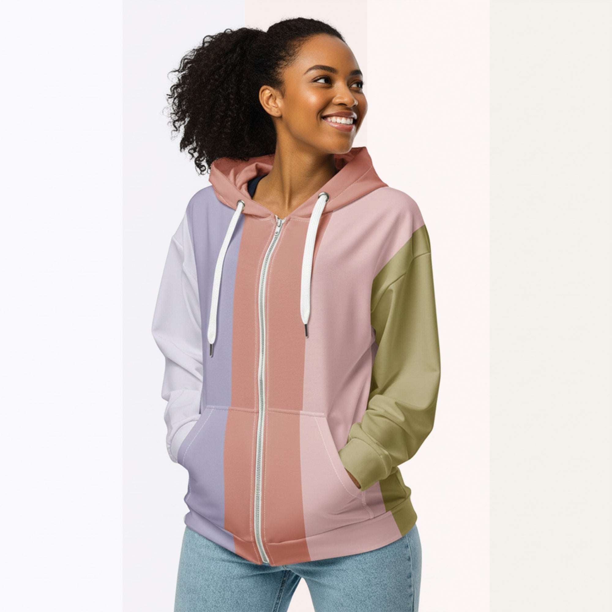 Three‑quarter side view of the second woman wearing the Her Palette Strip Hoodie No. 18; pastel vertical stripes accent the body and sleeves, lavender hood and white drawstrings, pastel striped backdrop, pocket detail visible from Form Finding Design.