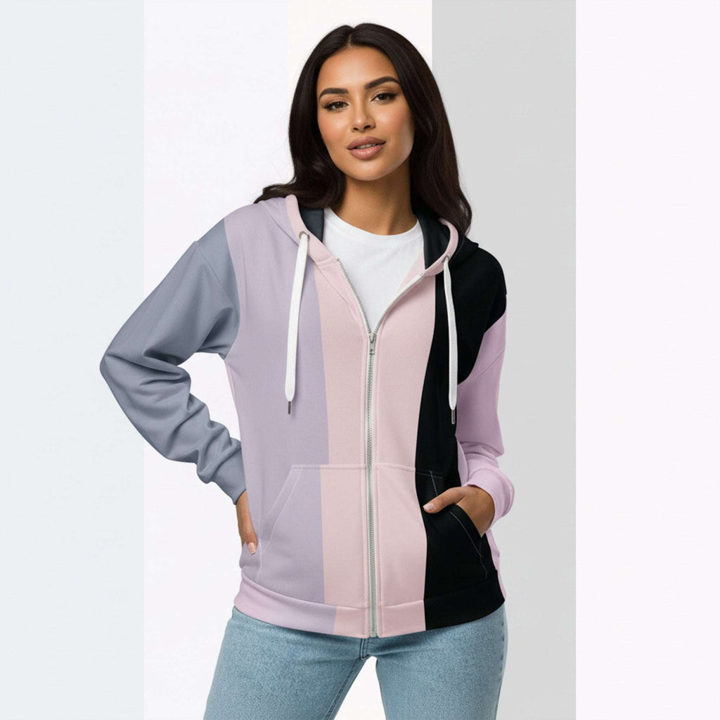 Front view of another woman wearing the Her Palette Strip Hoodie No. 11; pastel stripes cover the torso and sleeves, lavender hood lining and white zip, hands resting in the kangaroo pocket, pastel striped background from Form Finding Design.