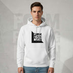 Front lifestyle portrait of male model wearing Form Finding Design Men’s Signature Hoodie (FFD-15), white—bold black square logo print, drawstring hood and pouch pocket, styled with blue jeans.