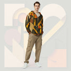 Male model wearing Form Finding Design Men’s Urban Utility Hoodie (No.06), front lifestyle portrait—earth-inspired geometric block print zip hoodie with kangaroo pockets and black drawstrings, styled with tan cargo trousers, minimalist architectural background.