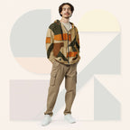 Male model wearing Form Finding Design Men’s Urban Utility Hoodie (No.07), front full-body—earth-tone geometric print zip hoodie with black drawstrings, styled with tan cargo trousers and white trainers, minimal architectural studio backdrop.