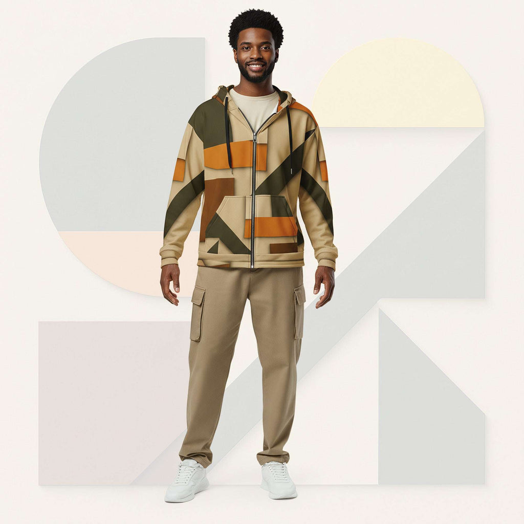 Lifestyle image of male model in Form Finding Design Men’s Urban Utility Hoodie (No.07), three-quarter stance—designer earth-palette geometric print highlighted across chest and sleeves, zip-front hoodie, neutral modern studio backdrop.