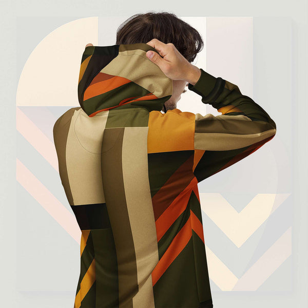 Form Finding Design Men’s Urban Utility Hoodie (No.08) —hoodie’s all-over earth-tone geometric print flowing across back and hood, paired with tan cargo trousers and white trainers, clean studio setting.