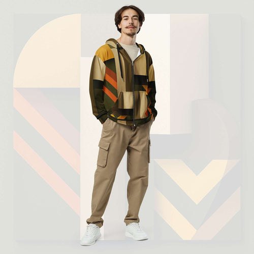 Male model wearing Form Finding Design Men’s Urban Utility Hoodie (No.08), front full-body—earth-tone geometric print zip hoodie with black drawstrings, styled with tan cargo trousers and white trainers, minimal architectural studio backdrop.