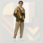 Male model wearing Form Finding Design Men’s Urban Utility Hoodie (No.08), front lifestyle portrait—earth-inspired geometric block print zip hoodie with kangaroo pockets and black drawstrings, styled with tan cargo trousers, minimalist architectural background.