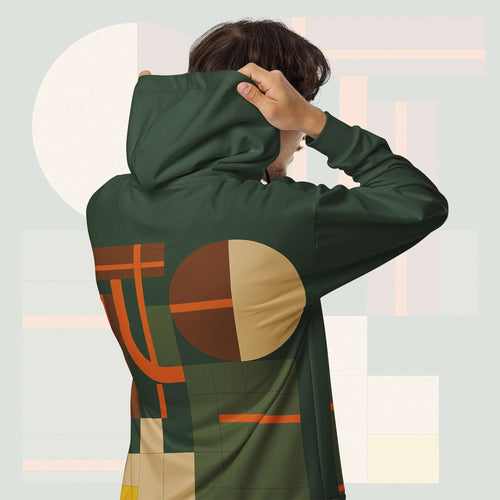 Form Finding Design Men’s Urban Utility Hoodie (No.11) —hoodie’s all-over earth-tone geometric print flowing across back and hood, paired with tan cargo trousers and white trainers, clean studio setting.