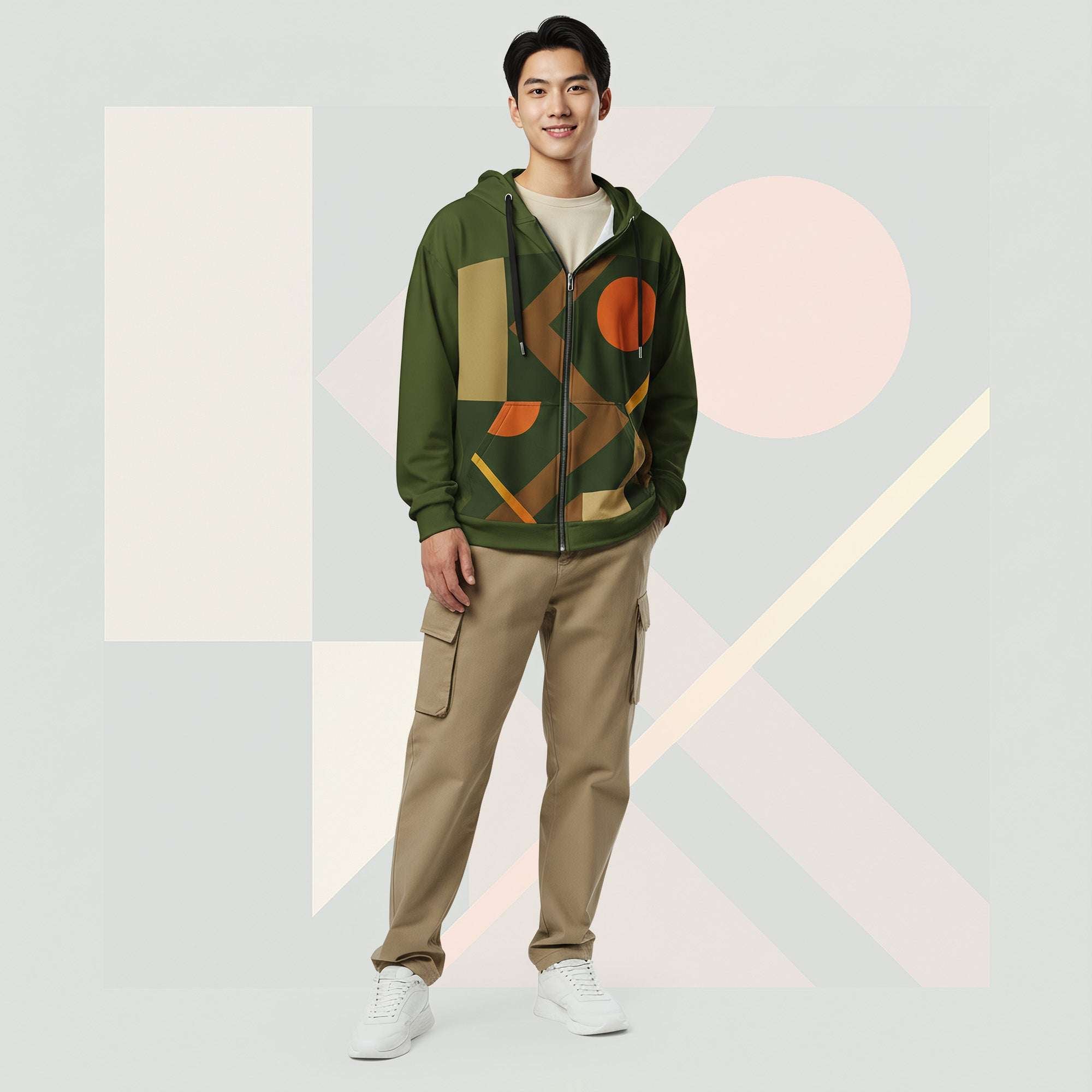 Lifestyle image of male model in Form Finding Design Men’s Urban Utility Hoodie (No.19), three-quarter stance—designer earth-palette geometric print highlighted across chest and sleeves, zip-front hoodie, neutral modern studio backdrop.