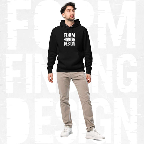 Male model wearing FormFD Men’s Signature Hoodie (FFD-08) in black with white square “FORM FINDING DESIGN” print, styled with beige chinos and white trainers, clean studio backdrop.