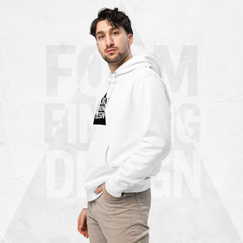 Three-quarter side portrait of male model in FormFD Men’s Signature Hoodie (FFD-11), white—hood drape, kangaroo pocket and partial chest logo visible, hand in pocket, beige chinos.