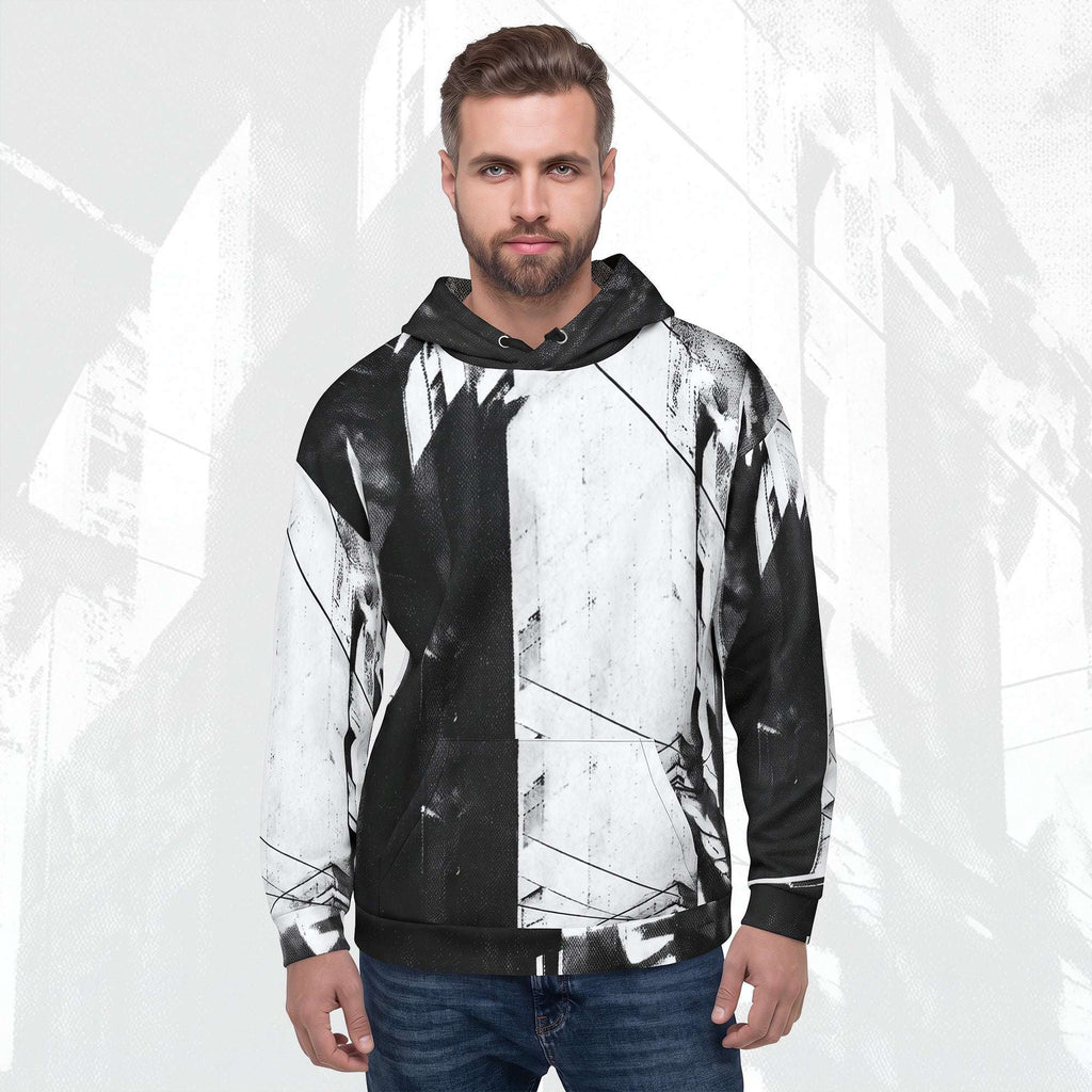 A man wearing a pullover hoodie with a black and white abstract brushstroke pattern, paired with blue jeans, set against a light gray background with faint architectural sketches.