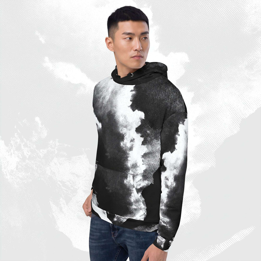 A man wearing a black and white cloud-patterned hoodie and blue jeans, standing against a light gray textured background.