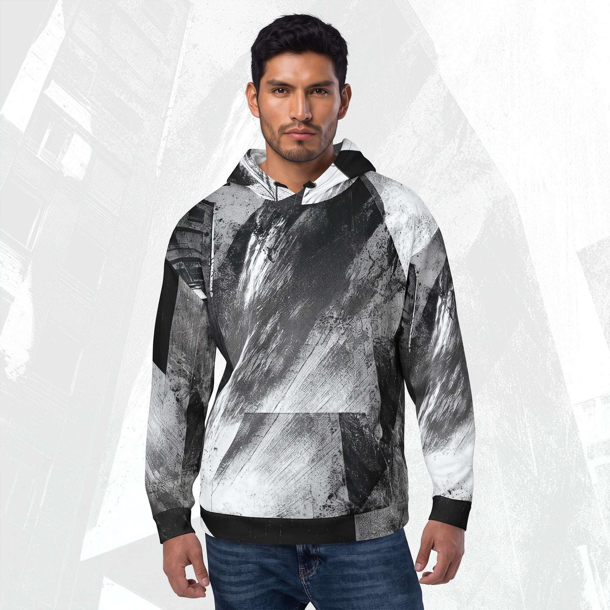 A man wearing a black, white, and gray abstract print hoodie with blue jeans, standing against a light gray background with a subtle cityscape graphic.