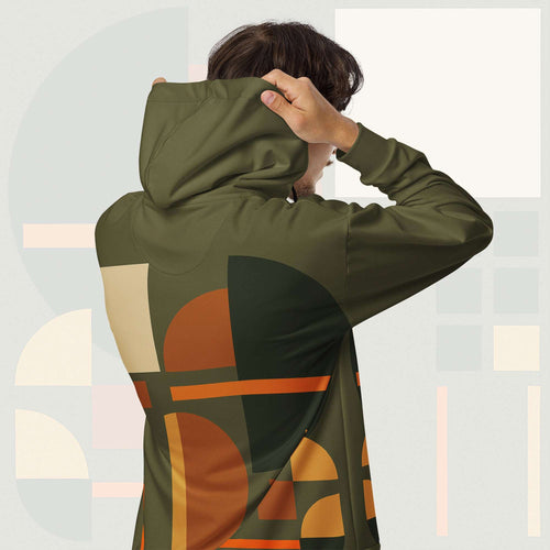 Form Finding Design Men’s Urban Utility Hoodie (No.12) —hoodie’s all-over earth-tone geometric print flowing across back and hood, paired with tan cargo trousers and white trainers, clean studio setting.