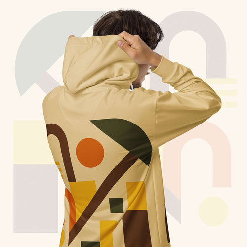 Form Finding Design Men’s Urban Utility Hoodie (No.16) —hoodie’s all-over earth-tone geometric print flowing across back and hood, paired with tan cargo trousers and white trainers, clean studio setting.