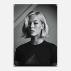 A black and white portrait print of a woman with short blonde hair wearing a dark T-shirt, shown as a vertical poster with visible mounting holes in the corners against a light gray background.