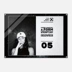 A rectangular acrylic or glass wall art print with rounded corners and visible corner hardware, shown against a light gray background. The print features a black-and-white design: the left half contains a black-and-white portrait of a woman wearing a cap, and the right half contains text reading 'UNDER ARMOUR x FORM FUNDAMENTALS STAMP CAP: SIGNATURE IMPRINTED HEADWEAR' with '05' below.