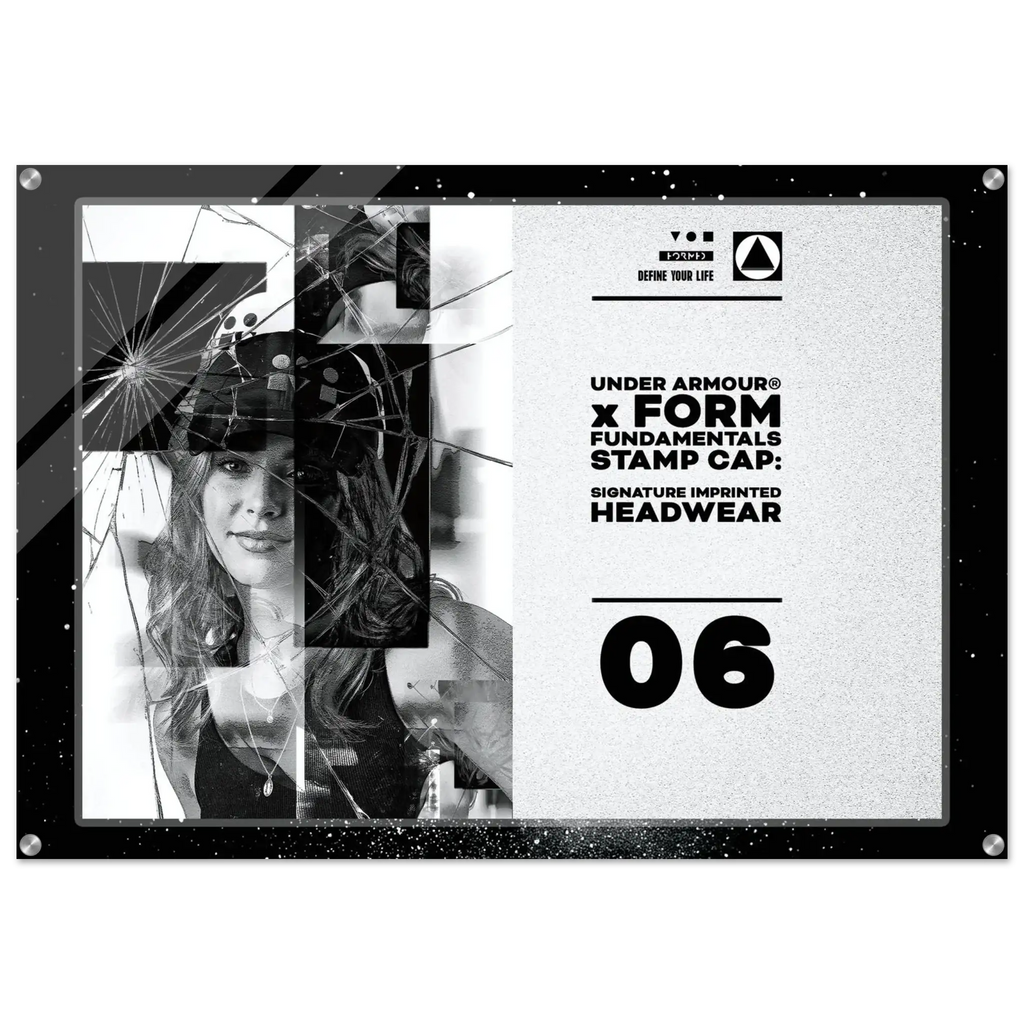 A square black acrylic stamp cap featuring a split design: one side shows a black-and-white photo of a woman broken by a spiderweb graphic overlay, and the other side displays text including 'UNDER ARMOUR x FORM FUNDAMENTALS STAMP CAP', 'SIGNATURE IMPRINTED HEADWEAR', and '06'.