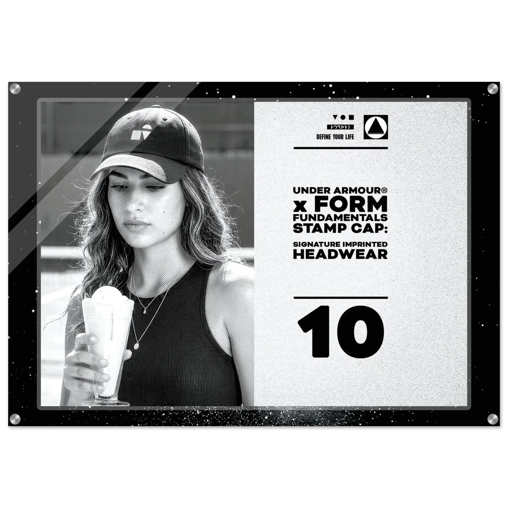 A rectangular promotional print or poster with a black border, featuring a black-and-white photo of a woman wearing an Under Armour cap and holding a drink, alongside printed text on a light background. The visible text includes 'UNDER ARMOUR x FORM FUNDAMENTALS STAMP CAP: SIGNATURE IMPRINTED HEADWEAR' and the number '10'.