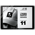 A framed black-and-white promotional print featuring a close-up of a person wearing a baseball cap with a large Under Armour stamp logo. The right side includes text reading 'UNDER ARMOUR x FORM FUNDAMENTAL STAMP CAP: SIGNATURE IMPRINTED HEADWEAR' and the number 11.