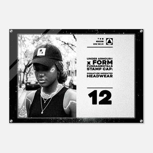 A black and white Under Armour x Form Fundamentals stamp cap design poster or print, featuring a black-and-white portrait of a woman wearing a cap on the left and product text including 'UNDER ARMOUR x FORM FUNDAMENTALS STAMP CAP' and 'SIGNATURE IMPRINTED HEADWEAR' on the right, all enclosed in a black frame with visible corner hardware.