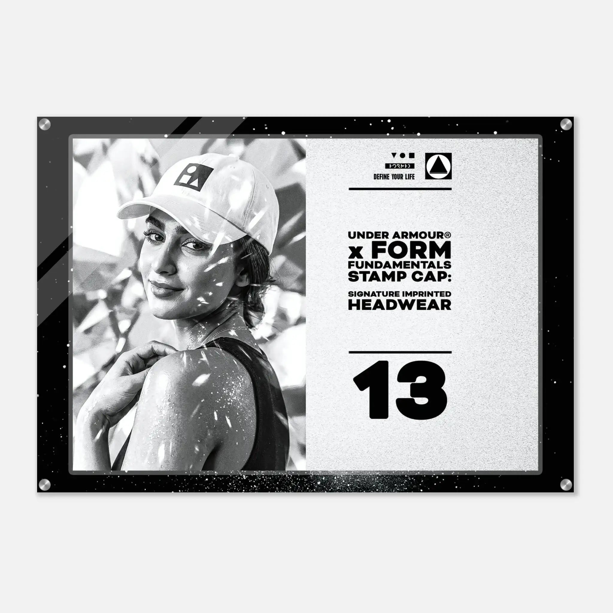 A rectangular Under Armour stamp cap headwear graphic print with a black border, featuring a black-and-white photo of a woman in a cap on the left and product text on the right, including 'UNDER ARMOUR x FORM FUNDAMENTALS STAMP CAP' and 'SIGNATURE IMPRINTED HEADWEAR' with the number 13.