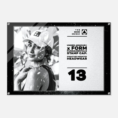 A rectangular Under Armour stamp cap headwear graphic print with a black border, featuring a black-and-white photo of a woman in a cap on the left and product text on the right, including 'UNDER ARMOUR x FORM FUNDAMENTALS STAMP CAP' and 'SIGNATURE IMPRINTED HEADWEAR' with the number 13.