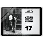 A rectangular framed stamp cap print featuring a black-and-white street photo of a person tying shoes beside a pole, alongside large text reading 'UNDER ARMOUR x FORM FUNDAMENTALS STAMP CAP: SIGNATURE IMPRINTED HEADWEAR' and the number '17'.