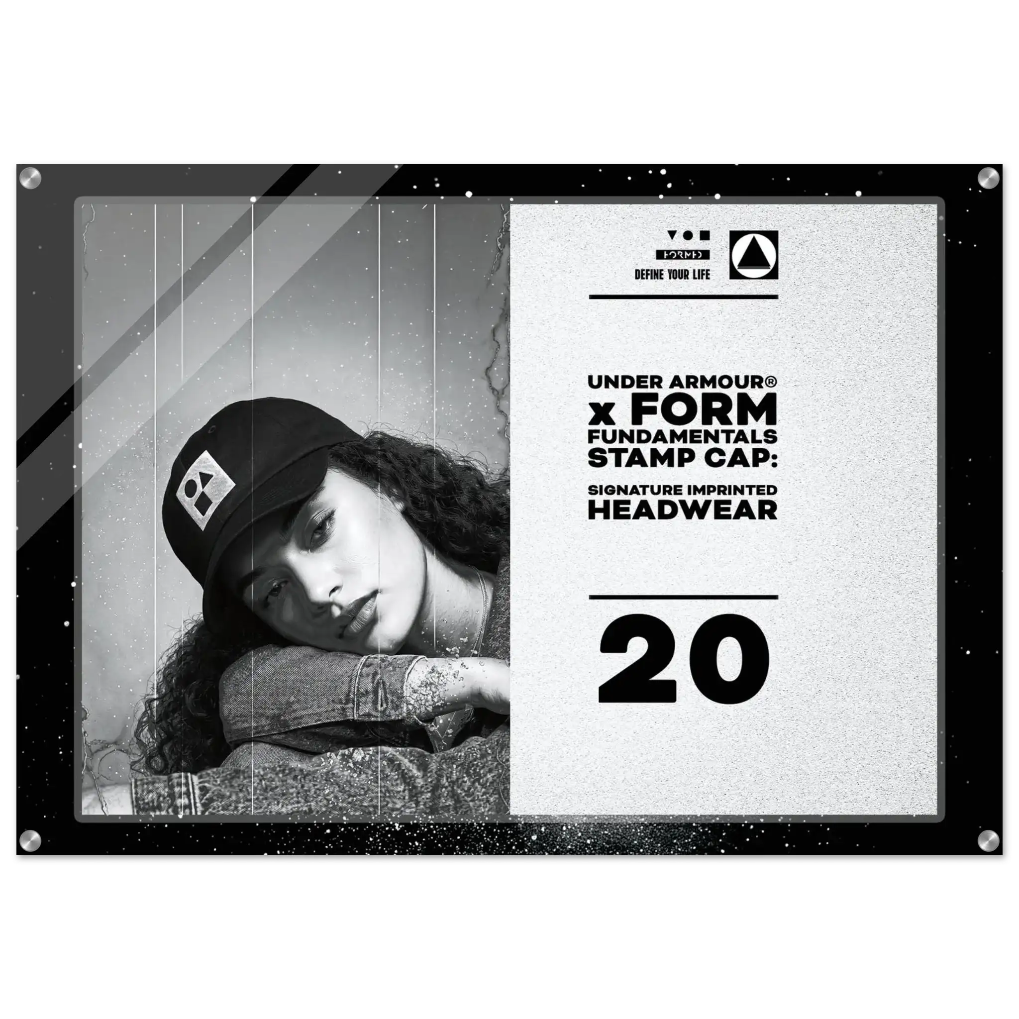 A rectangular acrylic or glass stamp cap plaque featuring a black-and-white photo of a woman wearing a cap on the left and printed text on the right. Visible branding includes Under Armour and Form Fundamentals Stamp Cap, with the number 20 prominently displayed.