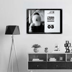 A framed black-and-white poster hanging on a light gray wall above a white and dark wood shelf, with a black tripod floor lamp on the left. The poster features a mirror selfie of a person wearing a white cap and bold text from Form Finding Design.