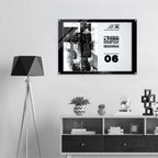 A black-framed wall art print with a black-and-white graphic design hangs on a light gray wall above a white and dark wood shelf. The print includes text reading from Form Finding Design.
