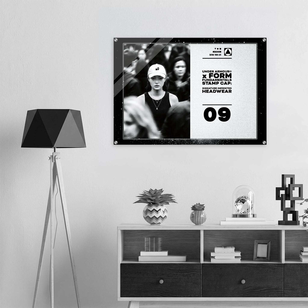 Framed artwork on a wall above a shelf with decorative items