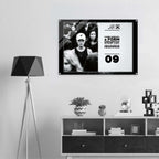 Framed artwork on a wall above a shelf with decorative items