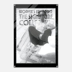 Person sitting in a shopping cart with text about women's empowerment on a poster.