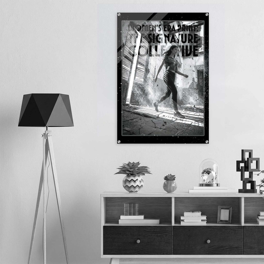 Framed poster of a woman running with text on a wall above a shelf with decor items.