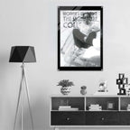 Poster of a woman in a shopping cart on a wall above a shelf with decor items.