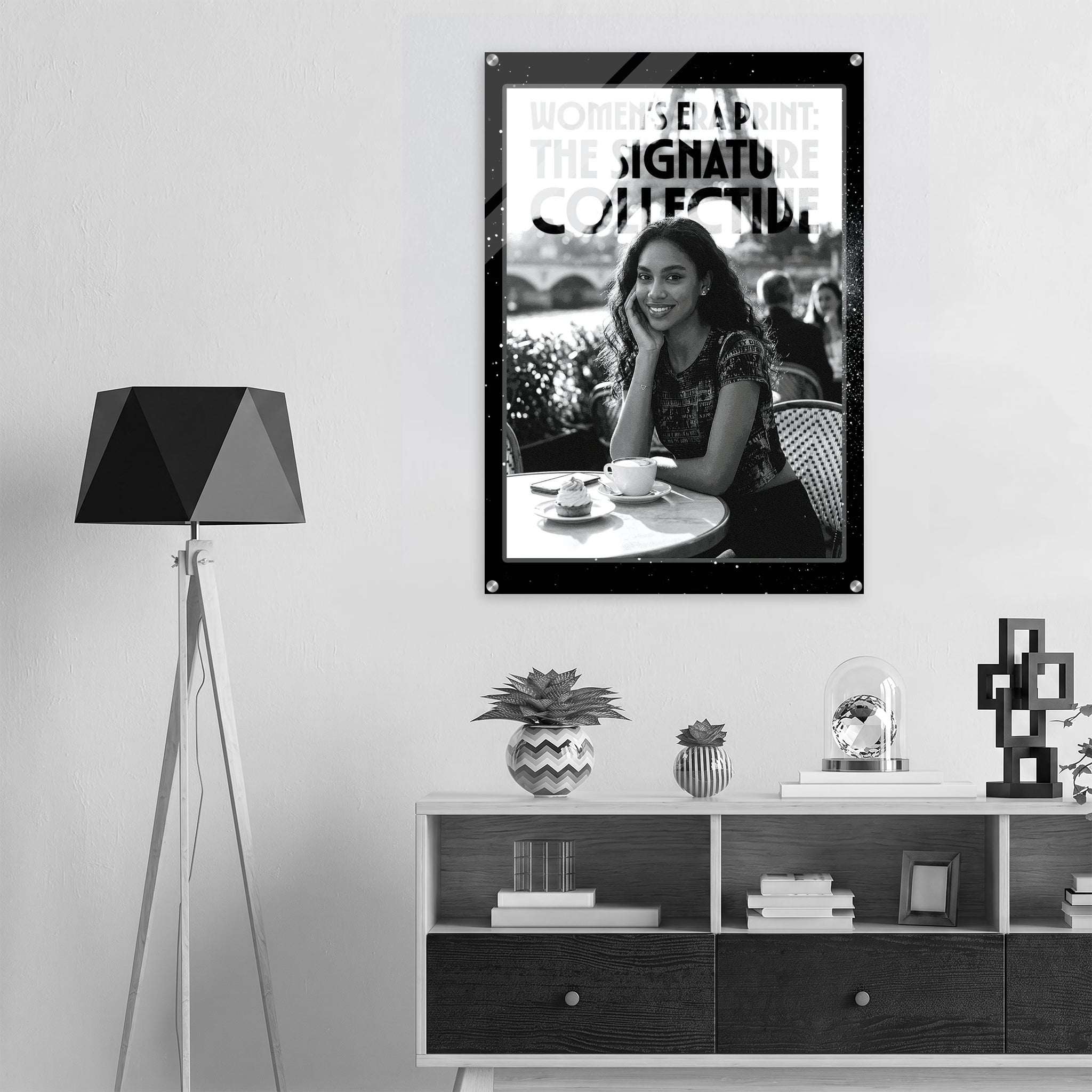 Framed photo of a woman sitting outdoors with decorative items on a shelf below.