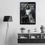 Poster of a woman and wolf with text on a wall above a shelf with decor items.