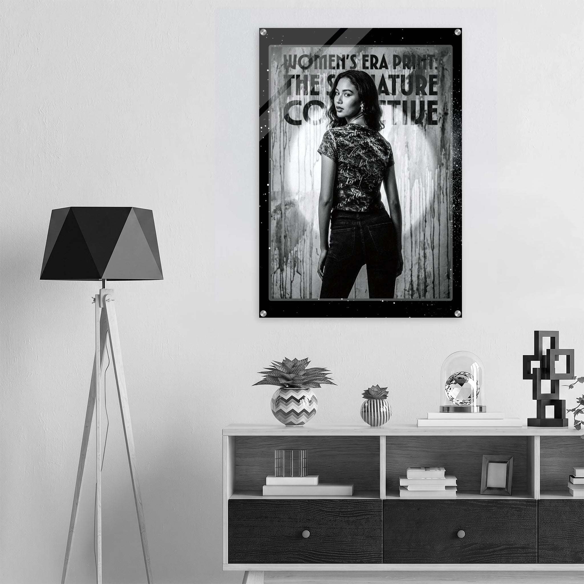 Poster of a woman in a stylish outfit on a wall above a shelf with decor items.