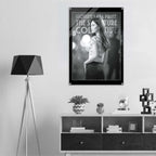 Poster of a woman with text on a wall above a shelf with decorative items.