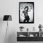 Framed poster of a woman in a stylish pose on a wall above a shelf with decor items.