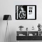 Framed poster of a woman on a wall above a shelf with decorative items.