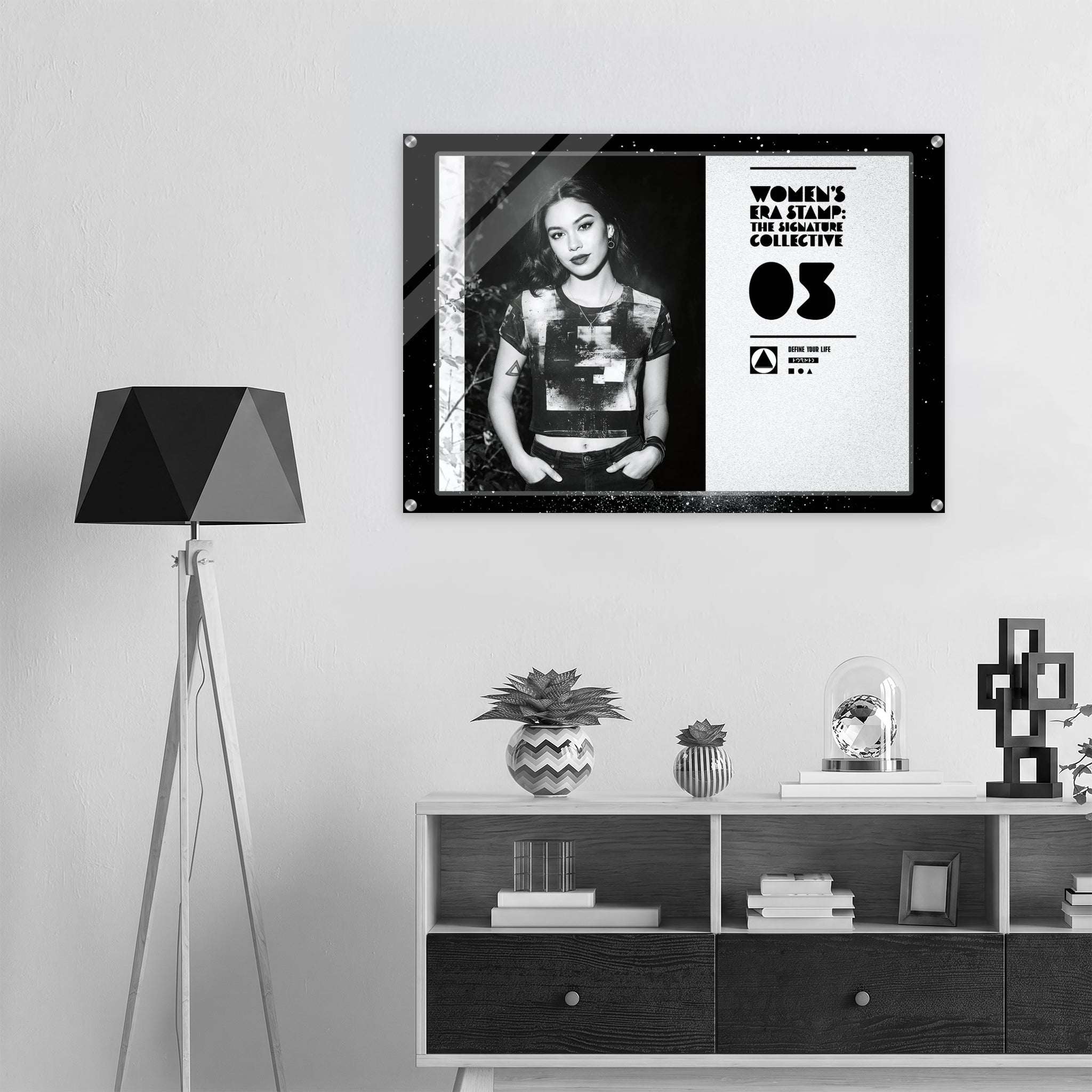 Framed poster of a woman on a wall above a shelf with decorative items.