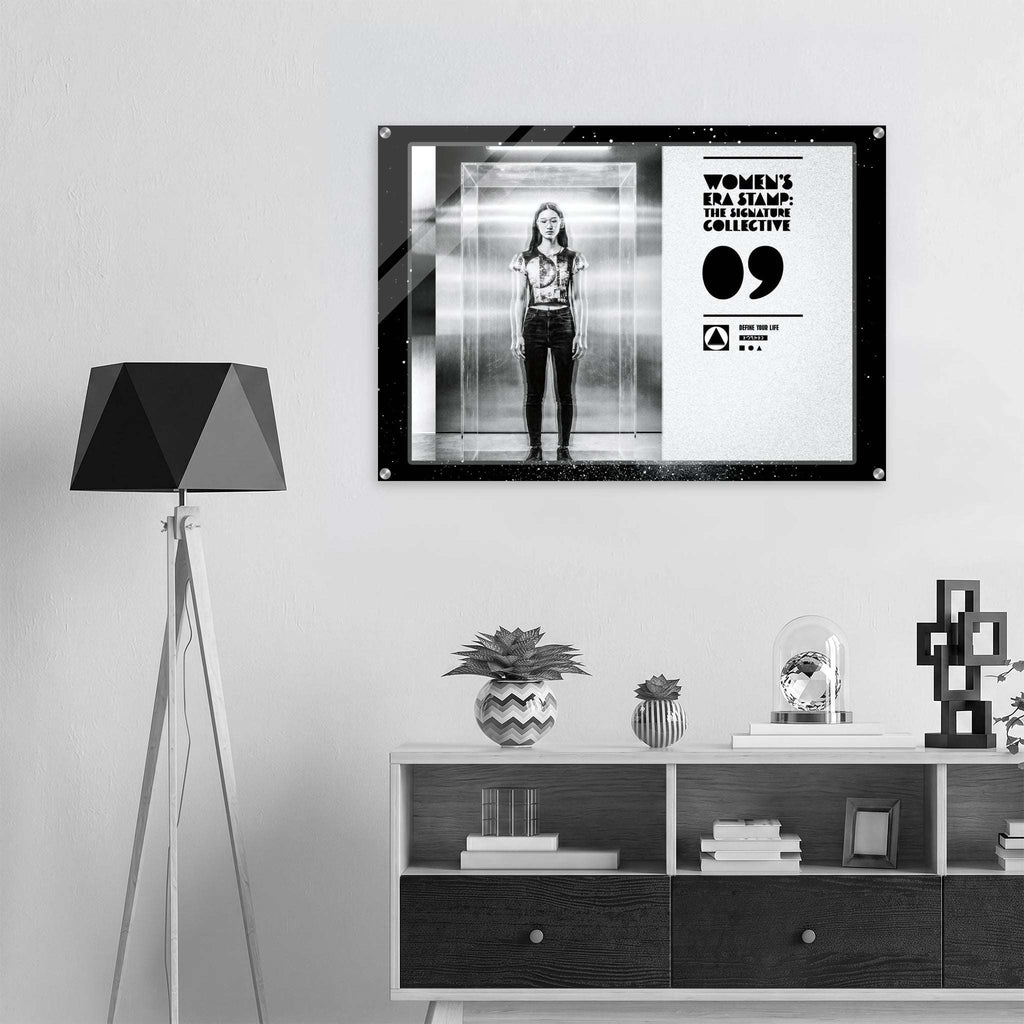 Framed artwork of a woman in an elevator on a wall above a shelf with decorative items.