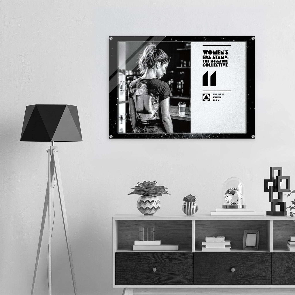 Framed poster of a woman with a tattoo on her back in a room with a lamp and shelves.